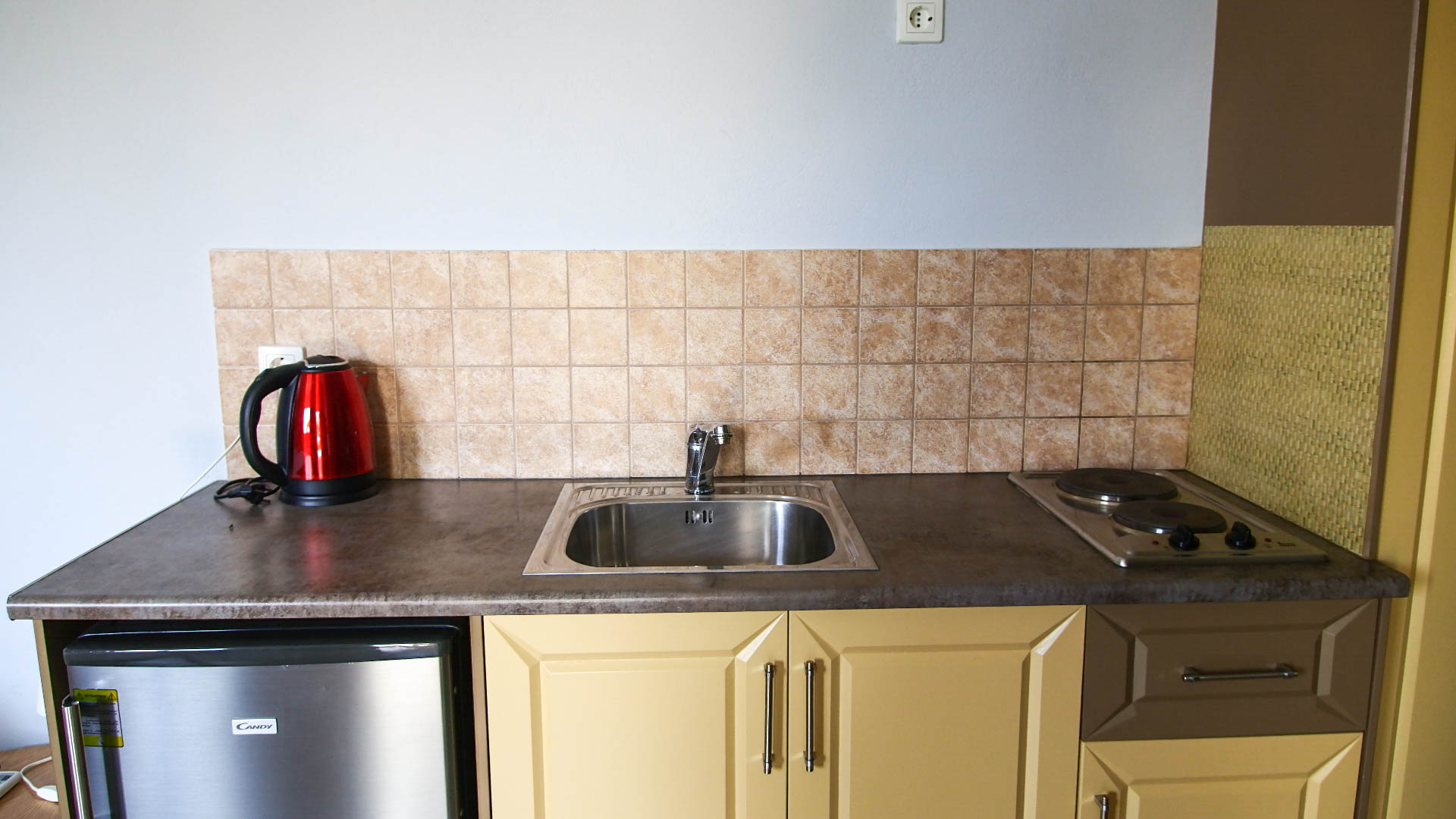Kitchen with a cooktop and all necessary cooking equipment